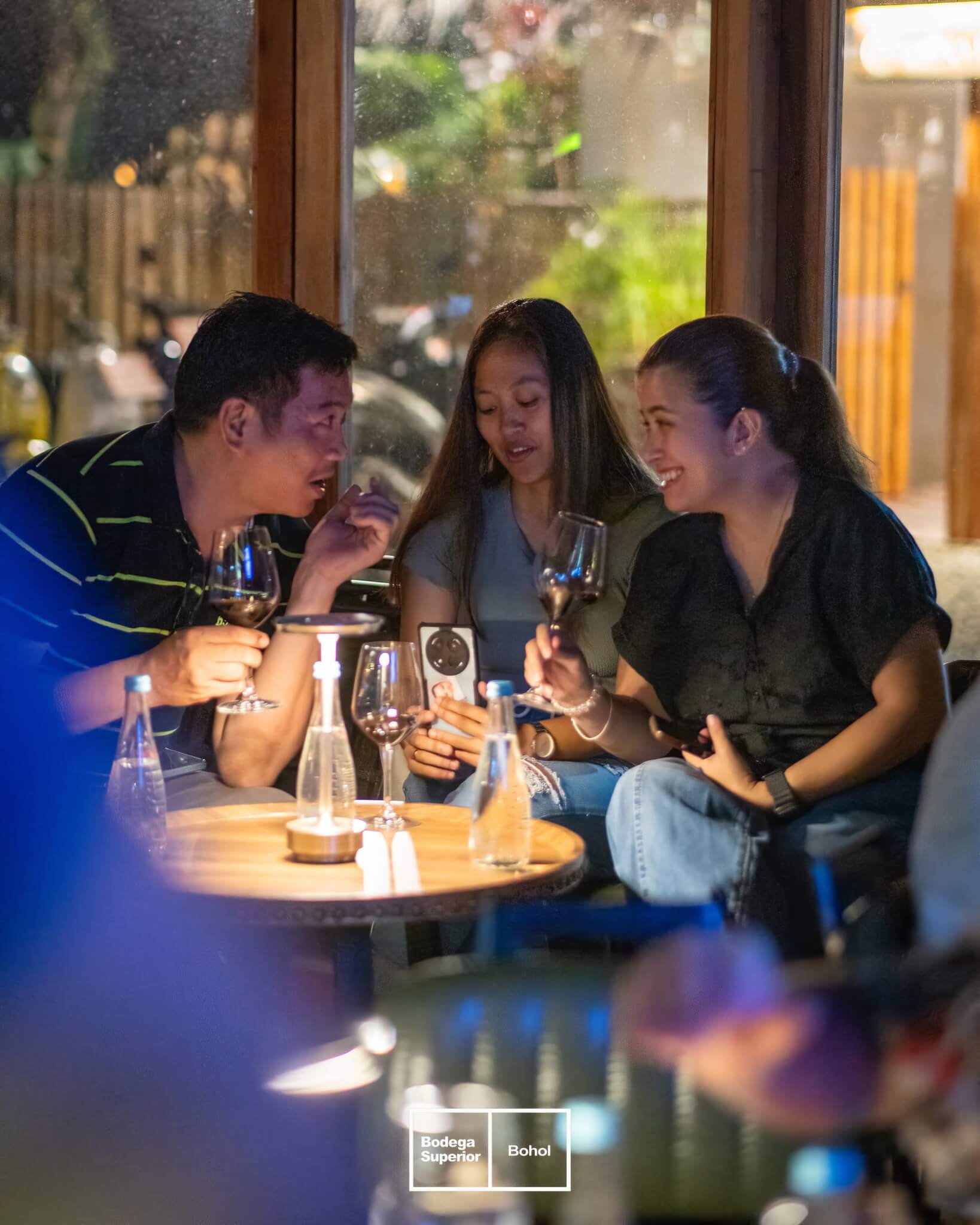 Guests sharing a bottle of wine at Bodega Superior, Panglao